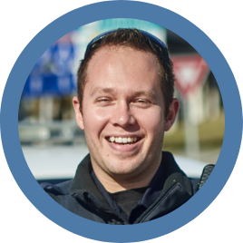 An image of a male uniformed officer smiling